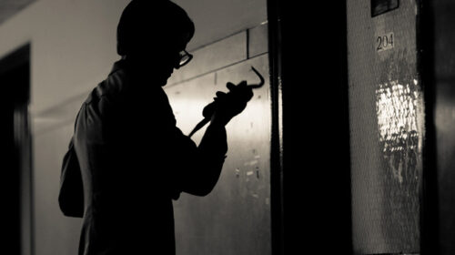 person breaking into safe