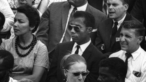 James Baldwin sitting in crowd 