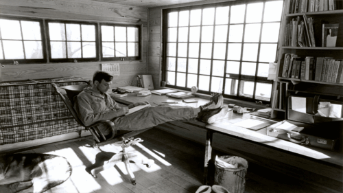 Wendell Berry reading at his desk 