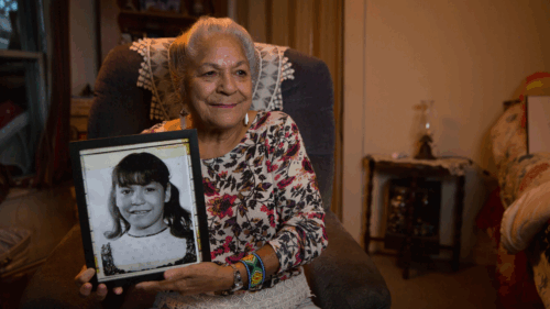 Native American woman with photo of child