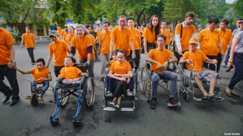 group of people in orange shirts march together