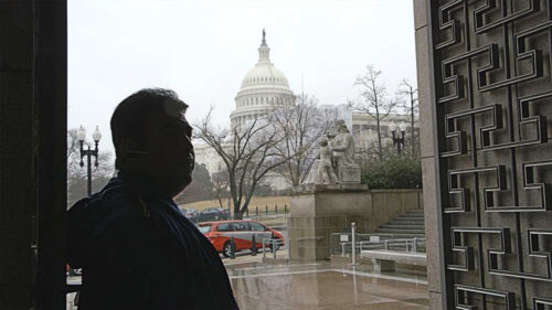 Man standing in front of capital building