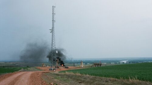 My Country, No More signature image featuring oil derrick in the middle of a farm