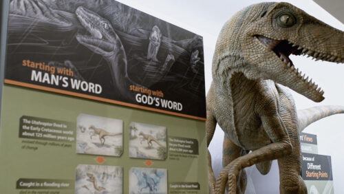 Gods word vs mans word with dinosaur replica 
