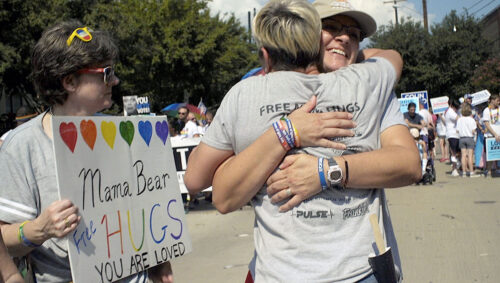 Women from Mama Bears support group hug in support of their LGBTQ children at a rally