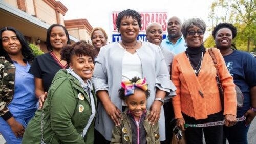 Stacey Abrams is surrounded by supporters on election day during her 2018 gubernatorial campaign in Georgia. Credit: Hatnim Lee 