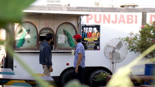 Dhabas director, Sami Khan, and showhost Rupak Ginn check out the menu at Punjabi Dhaba.