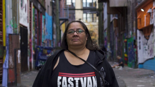 woman standing in alley way