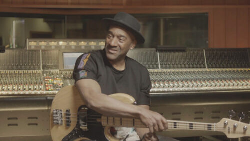 man in a recording studio playing a guitar