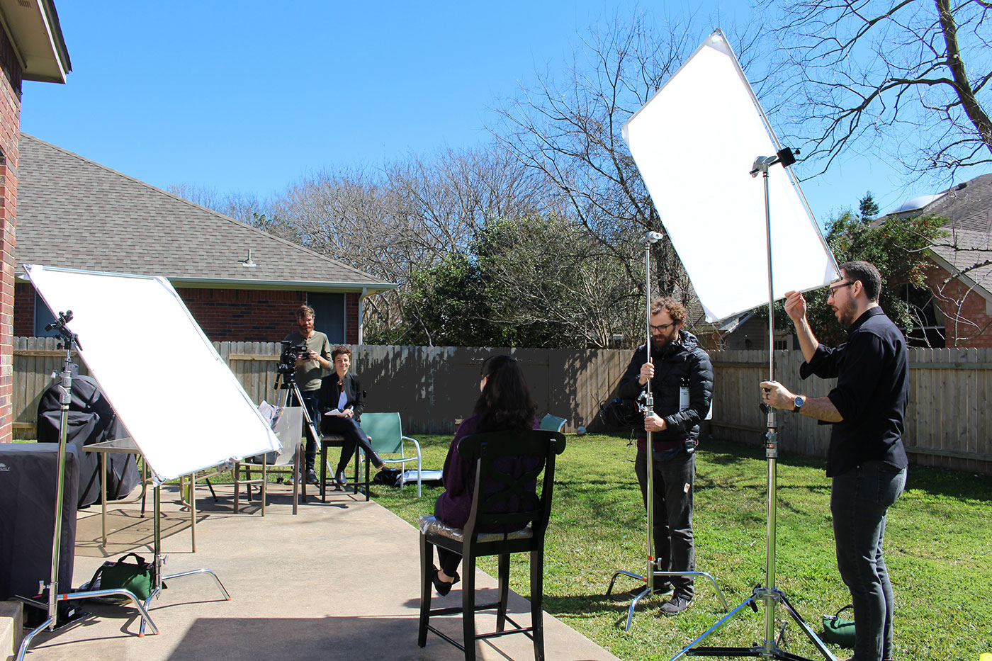 Patty Zagarella interviewing a subject in Texas, with crew around her.