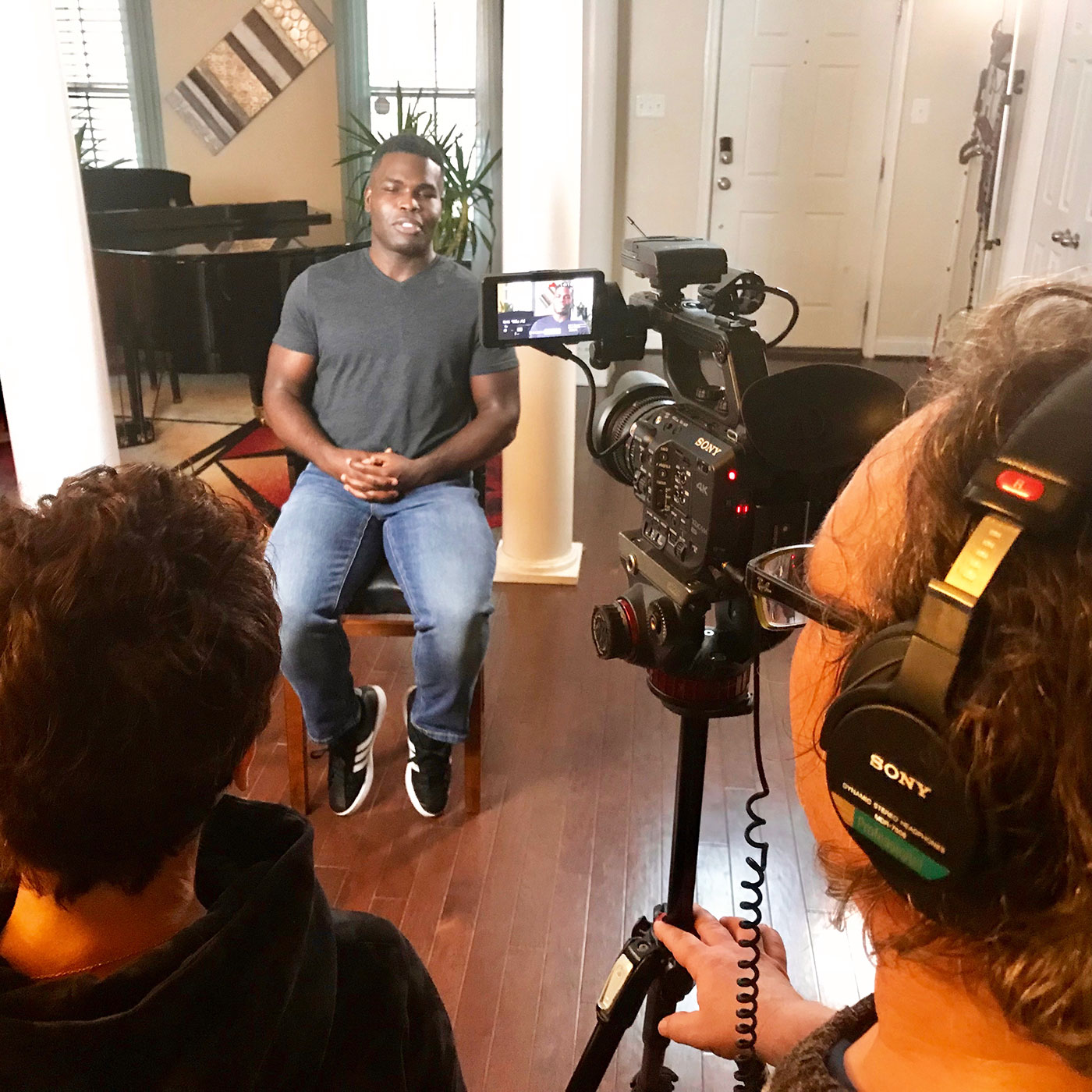 African American young man Mario being interviewed by Patty Zagarella and crew, for Blind Love