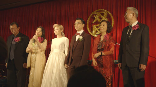 From the film Light of the Setting Sun, the filmmaker's family on stage celebrating a wedding