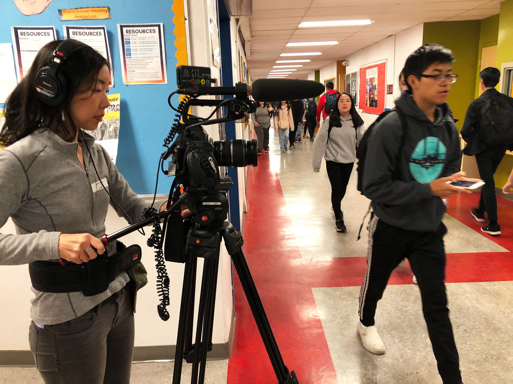 Behind Scenes shot of DP Kathy Huang filming halls of Lowell HS