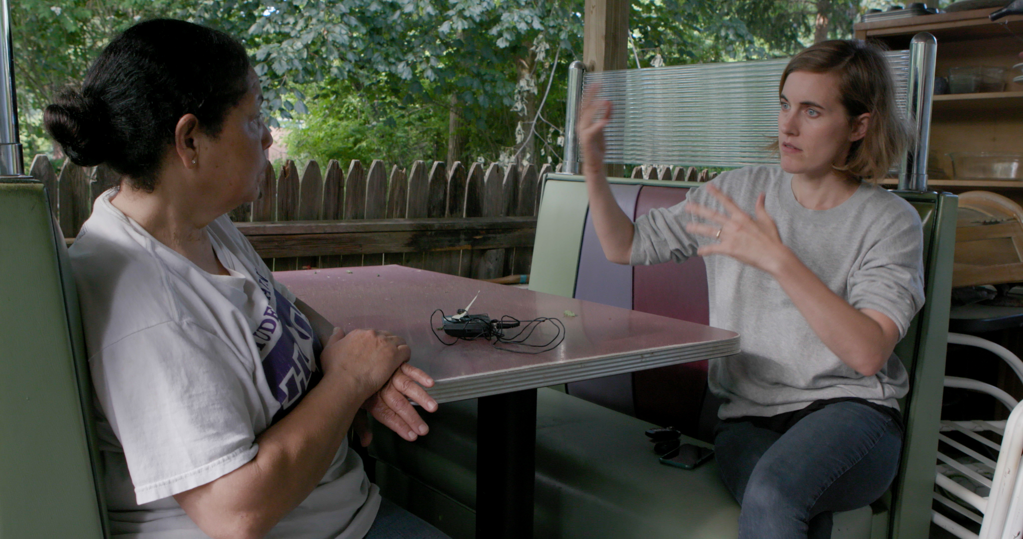 Treva Wurmfield while making Conscience Point, in conversation with her main subject while at a table