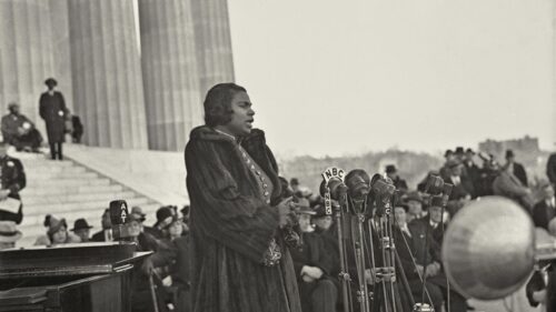 Marian Anderson stands in front of the statue of Lincoln at the Lincoln Memorial in Washington D.C