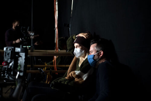 Move Me filmmakers Kelsey Peterson and Daniel Klein, both wearing face masks, looking at footage