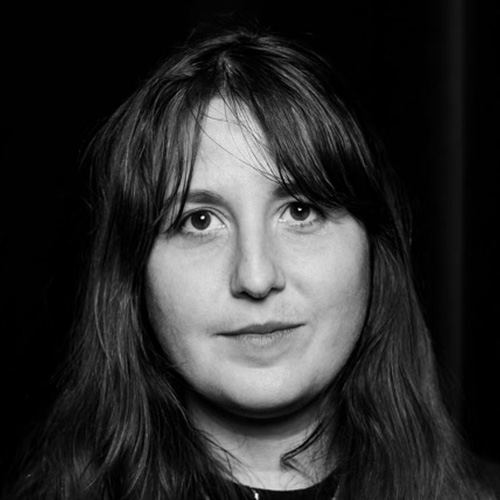 Woman with long dark brown hair, dark eyes and light tan skin tone