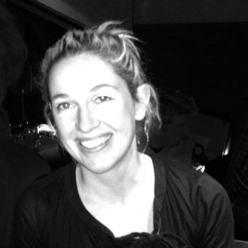 Woman with dirty blond hair smiling into the camera