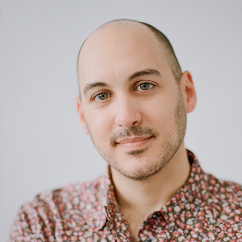 Headshot of man with bald head and light skin tone